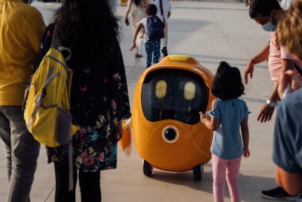 This is Opti. Who’s just one of a hundred robots that greet, photograph and serve visitors as well as giving them information.