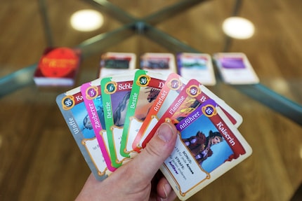 Foreground: the seven cards. Background: the draw pile and discard area.