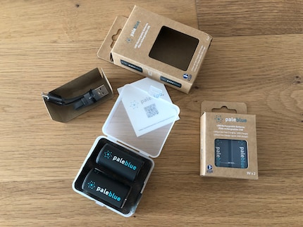Pale Blue included a hard plastic case with the batteries and a charging cable, all housed in a cardboard box.