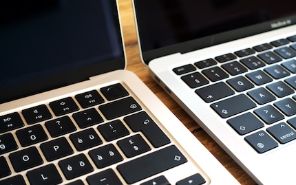 The M2 laptop on the left features invisible speakers.