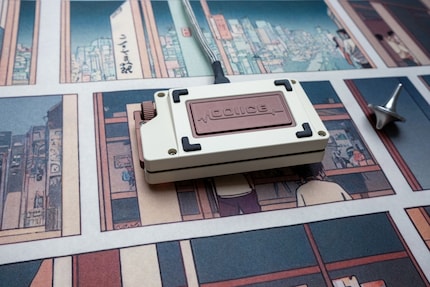 The Macro Pad Voice Mini has a decorated weight on the back.