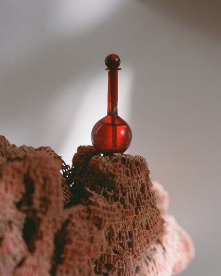 The red glass vials containing Forbidden Fruit lip oil are made in Illinois.