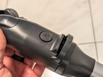 Electrolux has a lever and a button to separate the parts.