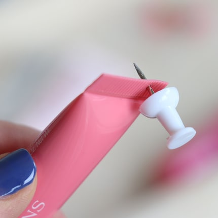 First, I pierce a hole with the pin.