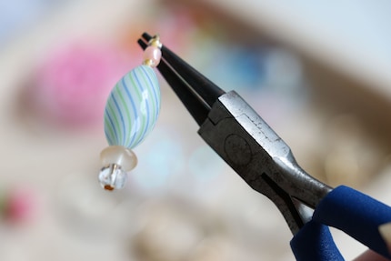 Here I have strung a few beads on a flathead needle and twisted the end of the wire into an eyelet.