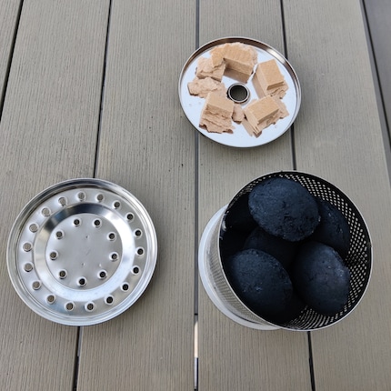 The charcoal container has an ignition tray and a lid. Just be careful not to overfill it.