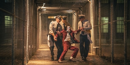 Arthur Fleck (or is it the Joker?) being harassed by Arkham Asylum guards.