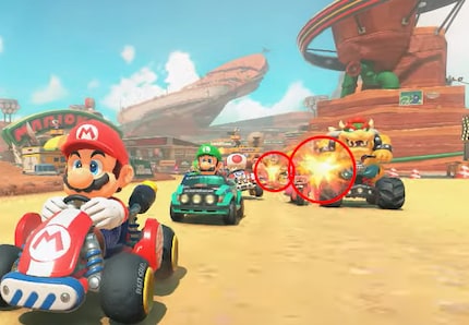 Twee hobbels: Peach en Bowser vechten op de voorgrond, met Donkey Kong en Daisy mogelijk erachter.