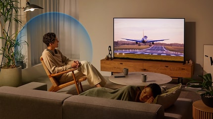 That must be a sensational landing he’s watching lost in thought while a woman in the foreground is sleeping peacefully.