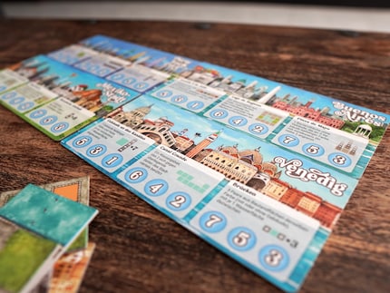 Eight double-sided city maps add variety to the game.