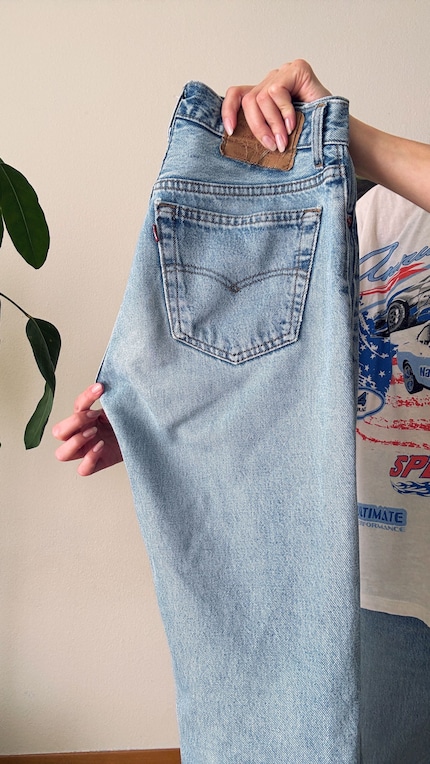 Fold the jeans lengthwise ...